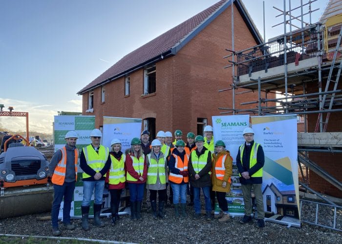 Barley Homes representatives, local members and builders on site in hi-viz and hard hats